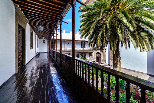 Nice interior patio with palm trees and corridor around the patio in sunny day and blue sky,