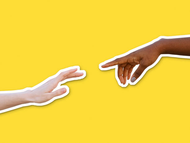 istock Collage cut outs of black and white human hands reaching each other 1300847465