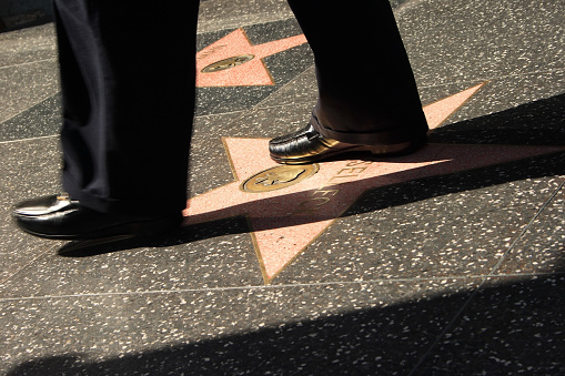 Los Angeles, California, USA - May 3, 2008: Walk of Fame, Hollywood, Los Angeles with a man walking on the stars.