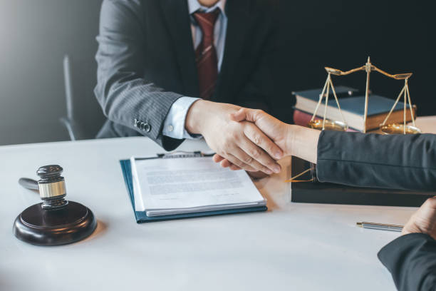 istock Businessman and lawyer shaking hands. 1300848603