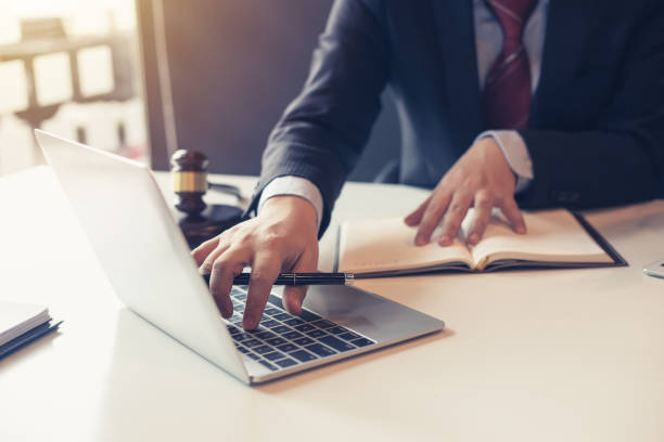 Lawyer using laptop for litigation information in law firms. stock photo