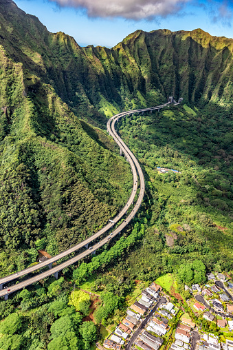 Oahu's H3 freeway curving through the beautiful mountainous terrain of inland island from an altitude of about 800 feet.