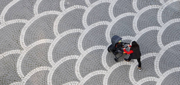 istock Mother Wearing Face Mask Walking Baby in Stroller 1300850335