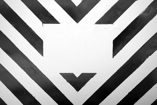 Abstract background with alternating black and white stripes with an empty copy space in the center. Stylish monochrome backdrop for information