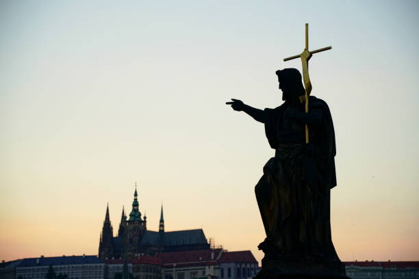 istock Cross-bearing statue on Charles Bridge in Prague at dusk 1300853216