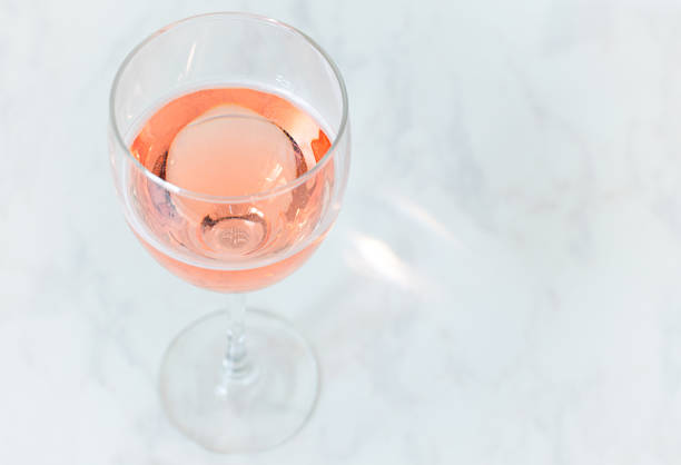 istock pink sparkling wine in a glass on a table with copy space 1300854536