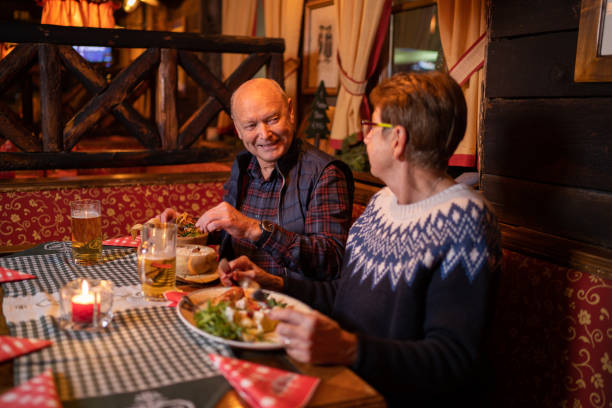 istock happy senior couple on winter vacations enjoying dinner in restaurant 1300857310