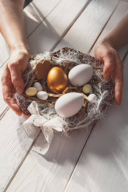 istock Easter zero waste, environmentally friendly gift wrapping kraft paper, eggs in a basket, gift basket, cozy religious Easter holiday, eco concept eco friendly decor banner on gray background 1300857319