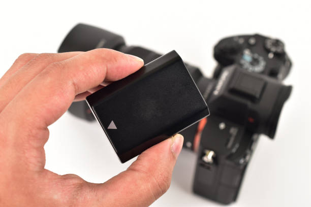 istock Hand holding rechargeable camera battery 1300857606