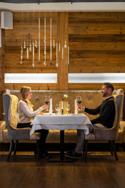 istock couple enjoying evening in luxury restaurant at table for two 1300858199
