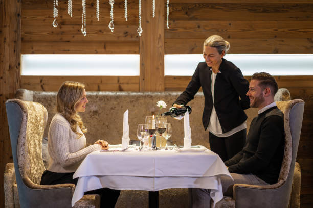 couple enjoying dinner for two in luxury restaurant - restaurant wine table table for two imagens e fotografias de stock