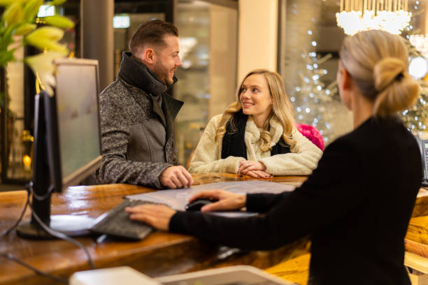 istock rich young couple at hotel reception in winter 1300858236