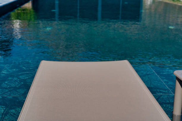 istock Summer vacation at poolside. Close up of sun bed. 1300858501