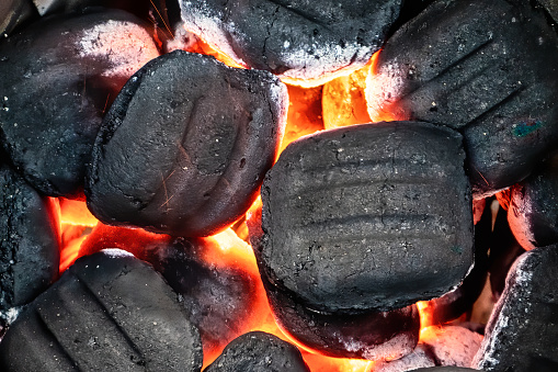 A close up of hot coals after lighting a BBQ.