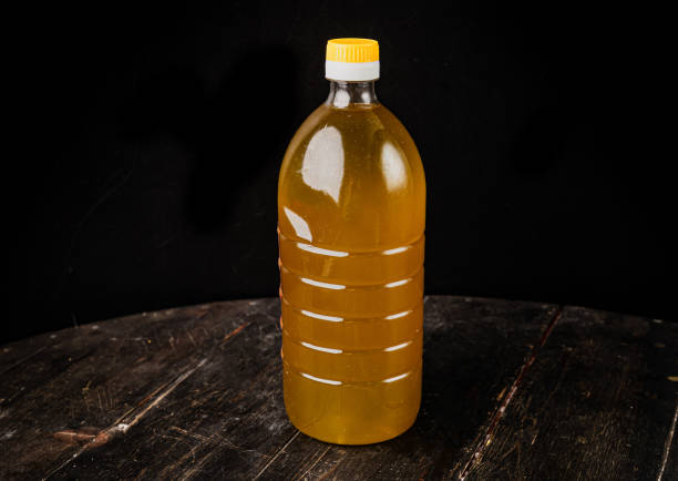istock Olive oil in a plastic bottle on a black background. 1300860446