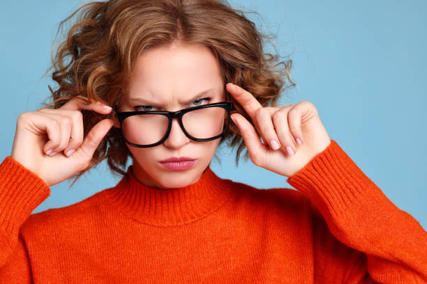 istock Curious woman in glasses looking at camera 1300865564