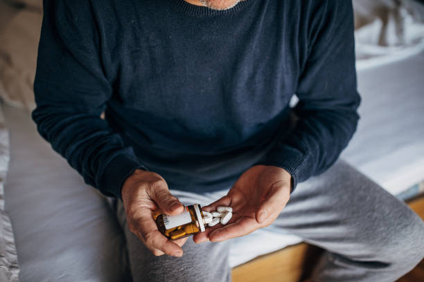 istock The sick person is taking medicine 1300865652