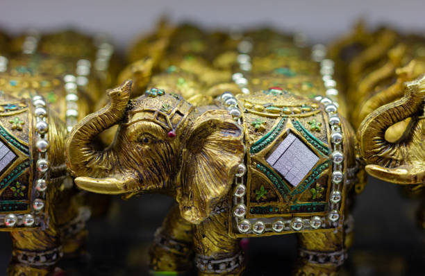 Golden colored elephant figures with trunk up Golden colored elephant figures with trunk up. Souvenir store gift, good luck concepts elephant figurine stock pictures, royalty-free photos & images