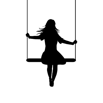 A young woman silhouette who is swinging