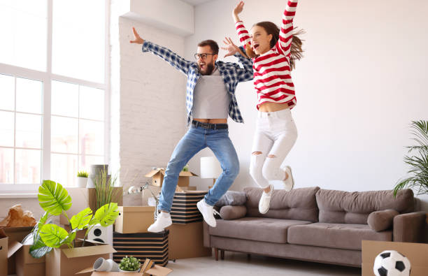 istock Excited couple celebrating relocation in new apartment 1300867395