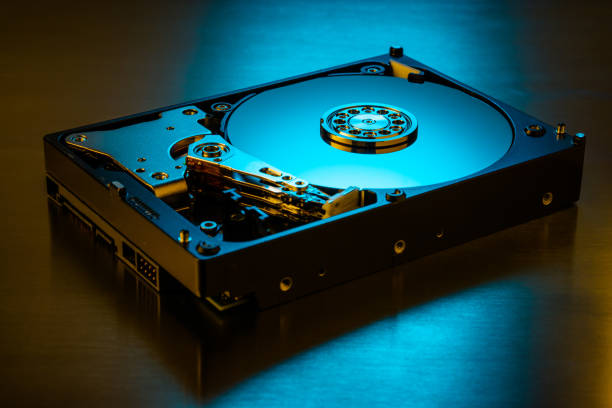 istock Inside of hard disk drive on the metal brushed background. 1300868033