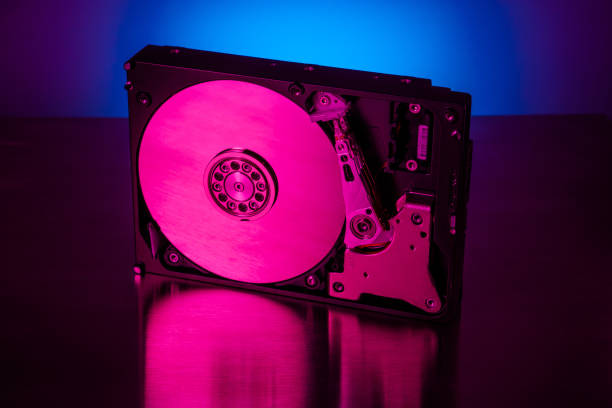 istock Inside of hard disk drive on the metal brushed background. 1300868104
