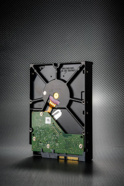 Inside of hard disk drive on the carbon background.