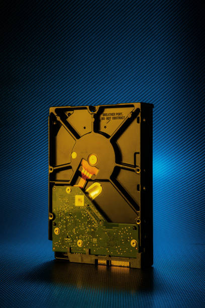 istock Inside of hard disk drive on the carbon background. 1300868329