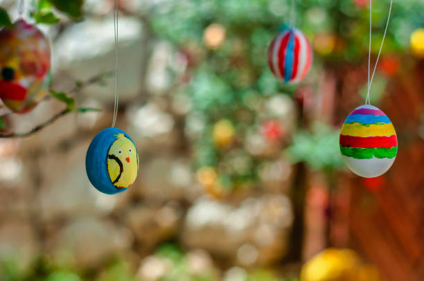 istock Colorful Easter eggs hanging on branches of a tree 1300868333