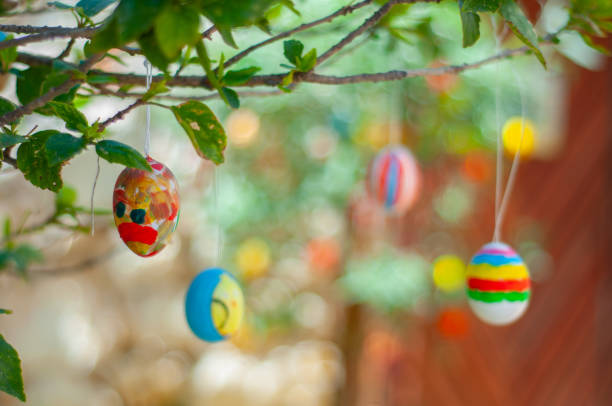 istock Colorful Easter eggs hanging on branches of a tree 1300868371
