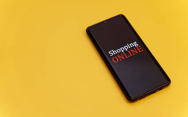 istock Smartphone on yellow background. Online shopping concept. 1300869207
