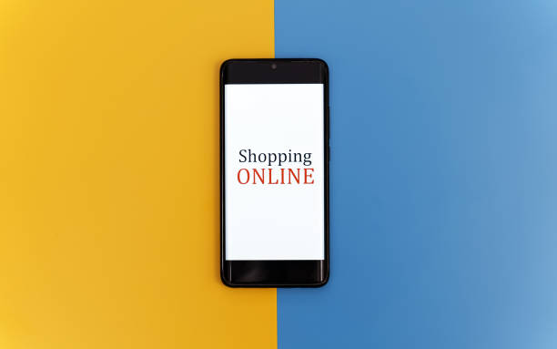 istock Smartphone on yellow and blue background. Online shopping concept. 1300870455