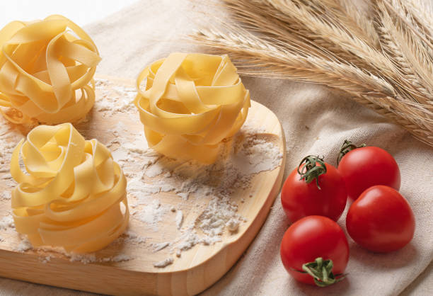 Italian pasta Tagliatelle from durum wheat. Pasta with flour and tomatoes