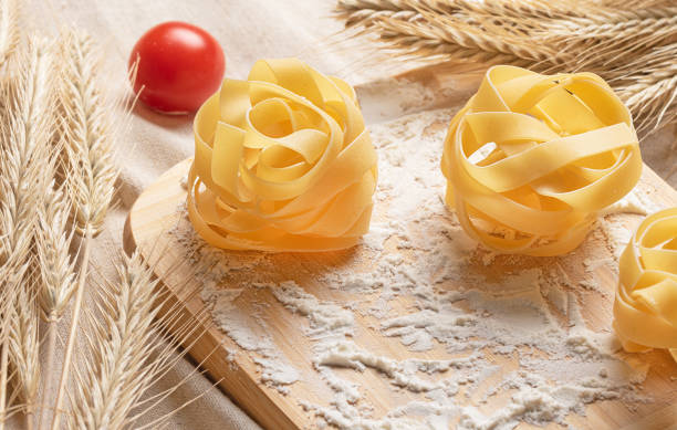 Italian pasta Tagliatelle from durum wheat. Pasta with flour and tomatoes