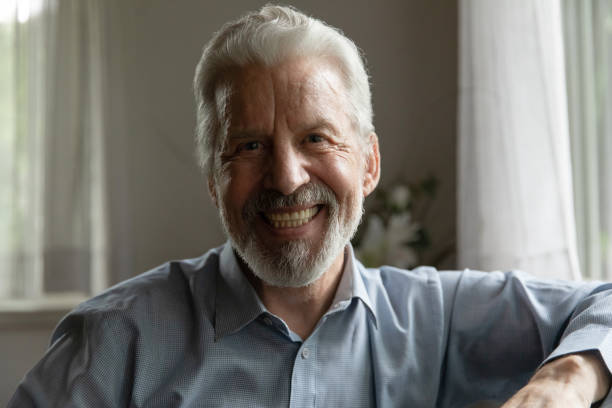 istock Head shot portrait smiling mature man looking at camera 1300870963