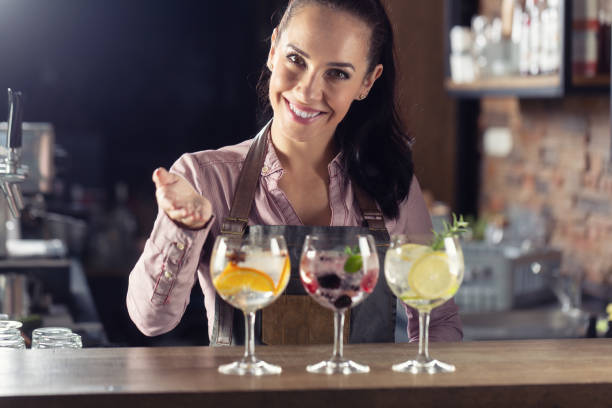 istock Bartender offers selection of various gin tonic drinks served on a bar. 1300870965