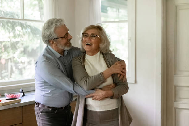 istock Overjoyed mature man and woman dancing in kitchen, having fun 1300871007