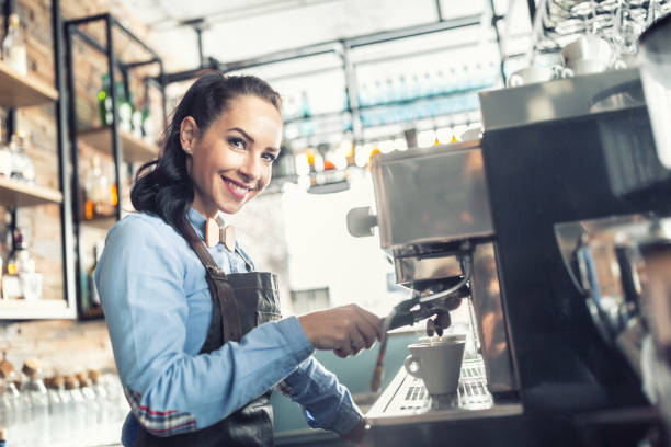 istock Beautiful barista makes espresso on a professional coffee maker in a cafe. 1300871017