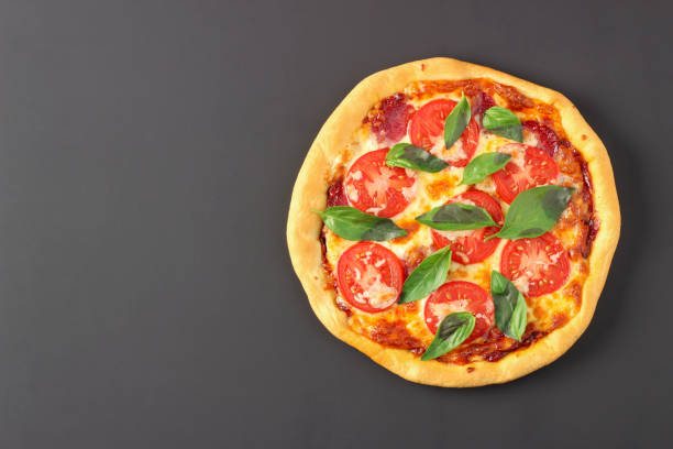 istock Pizza with cheese, sausage and tomatoes 1300875941