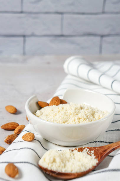 istock almond flour in a bowl and spoon with scattered nuts 1300876311