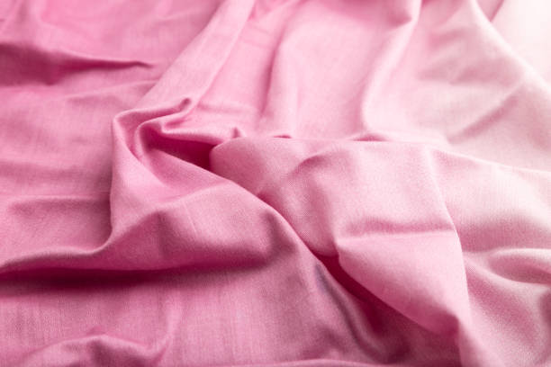 istock Fragment of cotton purple tissue. Side view, natural textile background and texture. wave concept, abstract. 1300876406
