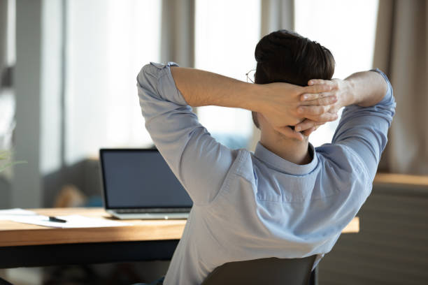 istock Happy young male worker employee resting on chair during workday. 1300879277