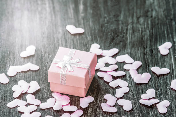 istock Gift box with hearts on a wooden background. Valentine`s day. 1300879366