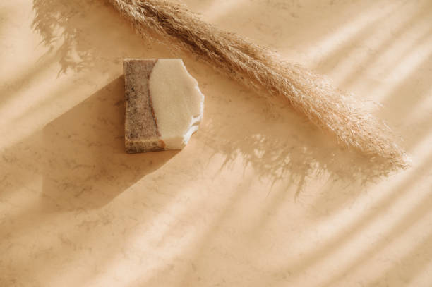 istock Handmade soap and pampas grass. Sunshade shadow on beige background. Zero waste, eco friendly cosmetics concept. Vintage color filter 1300879372