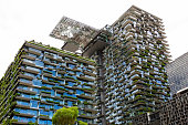 Low angle view of apartment buildings swith vertical gardens and heliostat, sky background with copy space