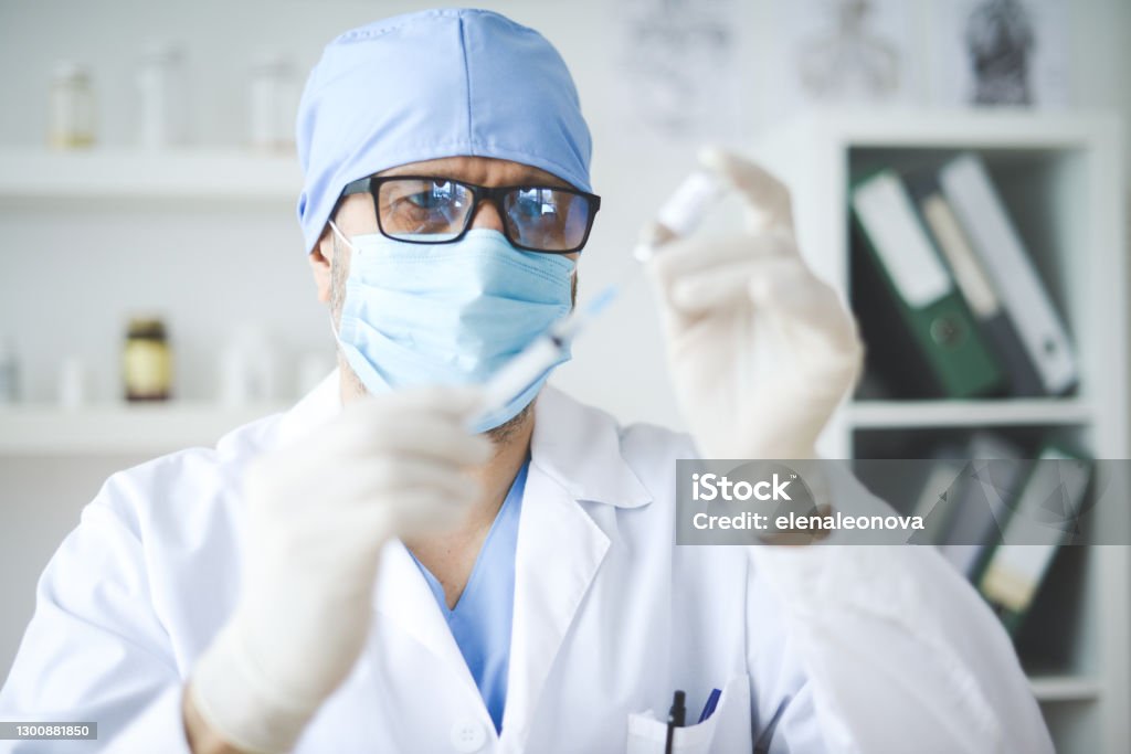 doctor holding a bottle of Covid-19 vaccine COVID-19 Vaccine Stock Photo