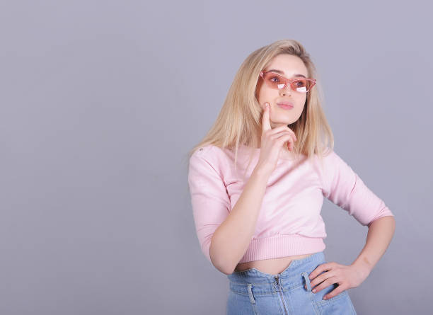 istock Smiling caucasian woman posing on gray background. 1300883295
