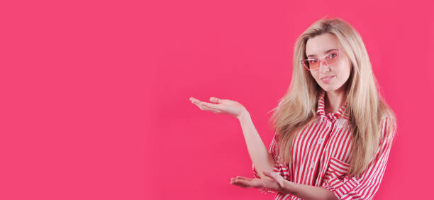 istock Beautiful smiling woman posing on red background. 1300883347