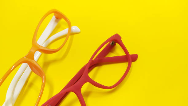 istock Fashionable glasses style plastic frame on yellow background 1300884824