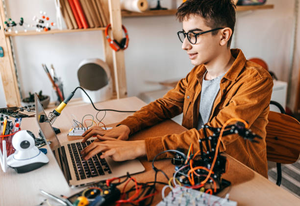 istock Teenage boy working on robotics project 1300886088